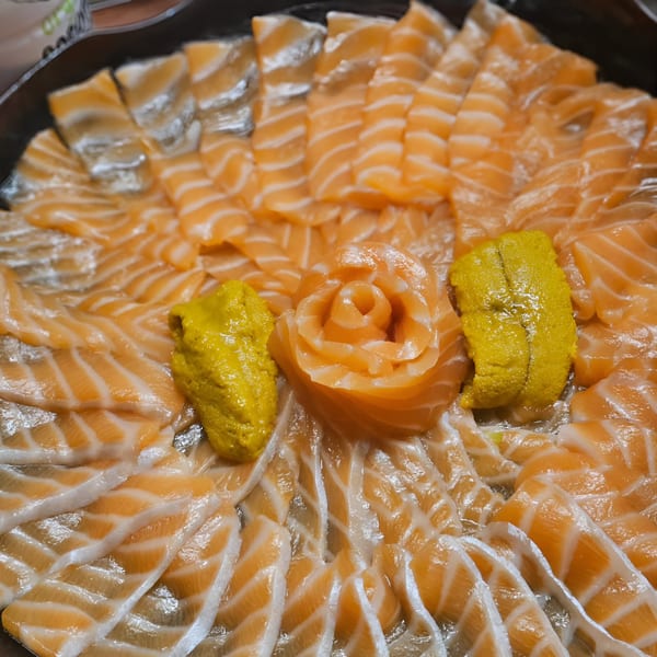 A platter of Kin Sushi's salmon sashimi, with a salmon rose and two dollops of uni.